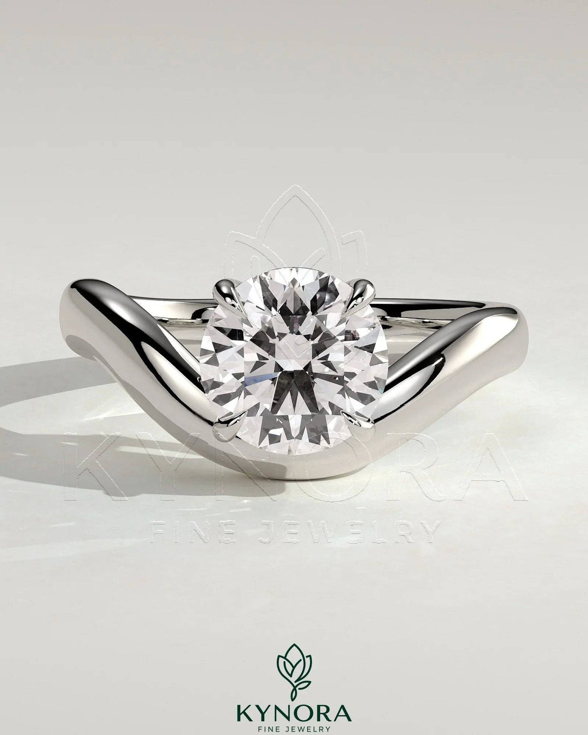 Kynora CJ 2ct round East-West claw solitaire engagement ring with wave band showcasing a sparkling central diamond.