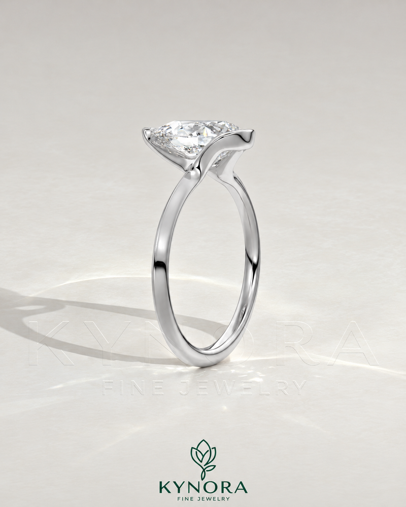 Pear cut moissanite half-bezel engagement ring in 925 silver, featuring a sleek design and detailed craftsmanship.