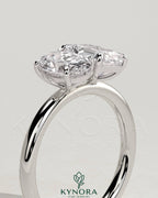 Kynora CJ Toi et Moi engagement ring featuring 1.05ct oval and 1.8ct emerald-cut diamonds, set in a delicate band.