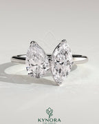 Kynora CJ Toi et Moi engagement ring featuring a 1.8ct pear-shaped and 1.5ct marquise-shaped diamonds in a claw setting.