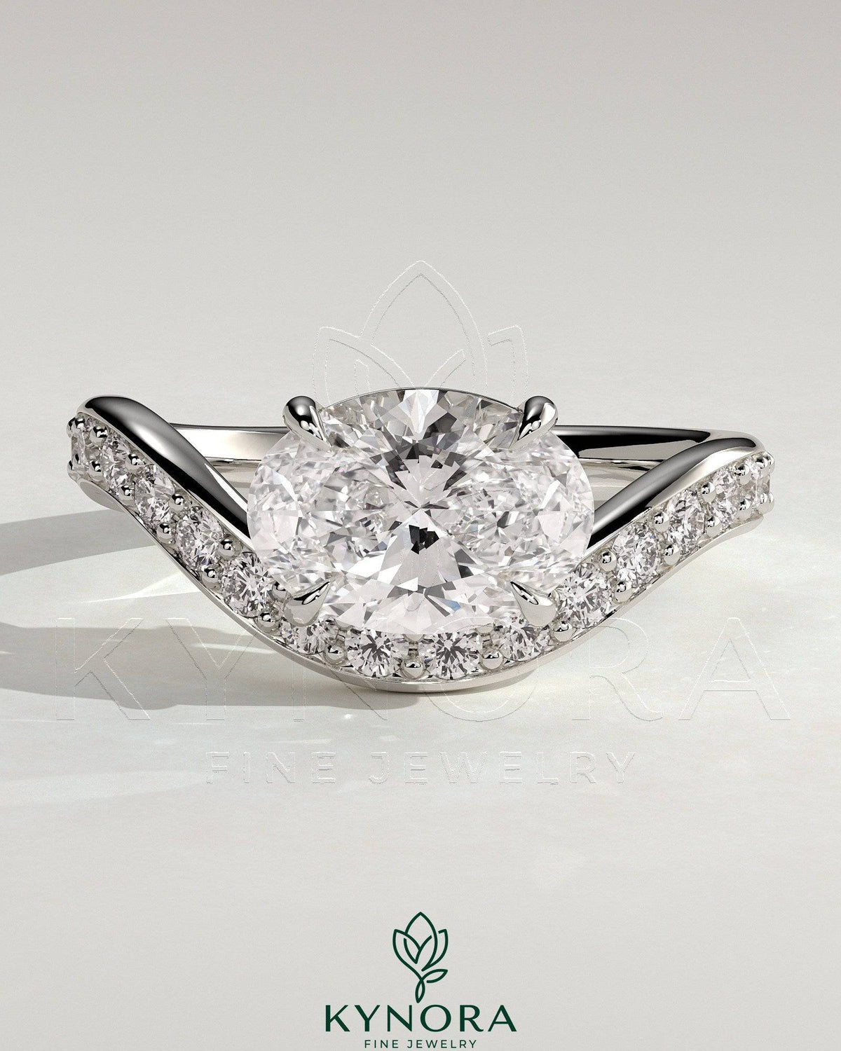Kynora CJ 2ct oval claw solitaire engagement ring with bead set pave wave band and east-west setting, showcasing elegant jewelry design.
