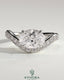 Kynora CJ 2ct oval claw solitaire engagement ring with bead set pave wave band and east-west setting, showcasing elegant jewelry design.