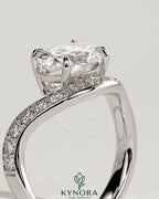 Kynora CJ 2ct oval claw solitaire engagement ring with bead set pave wave band and east-west setting, showcasing elegant jewelry design.