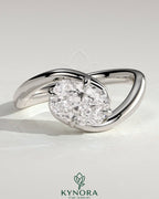 Kynora CJ 2ct elongated cushion cut diamond East-West claw solitaire engagement ring with bypass band, elegant and sparkling jewelry piece.