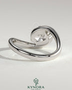 Elegant 2ct East-West cushion cut diamond engagement ring by Kynora CJ with bypass band and claw setting.