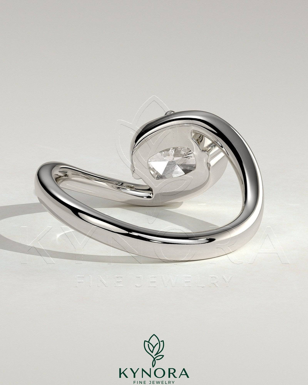 Elegant 2ct East-West cushion cut diamond engagement ring by Kynora CJ with bypass band and claw setting.