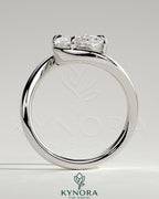 Elegant 2ct East-West Elongated Cushion Claw Solitaire engagement ring with bypass band by Kynora CJ, showcasing intricate design details.