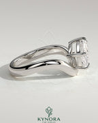 Kynora CJ 2ct elongated cushion cut diamond engagement ring with east-west setting and wave band design on a silver band.