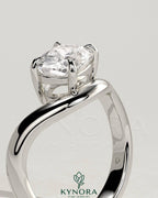 Kynora CJ 2-carat elongated cushion cut diamond engagement ring with east-west setting and wave band design.