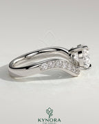 Kynora CJ 2ct pear-shaped diamond solitaire engagement ring with pave bead set wave band in east-west setting.