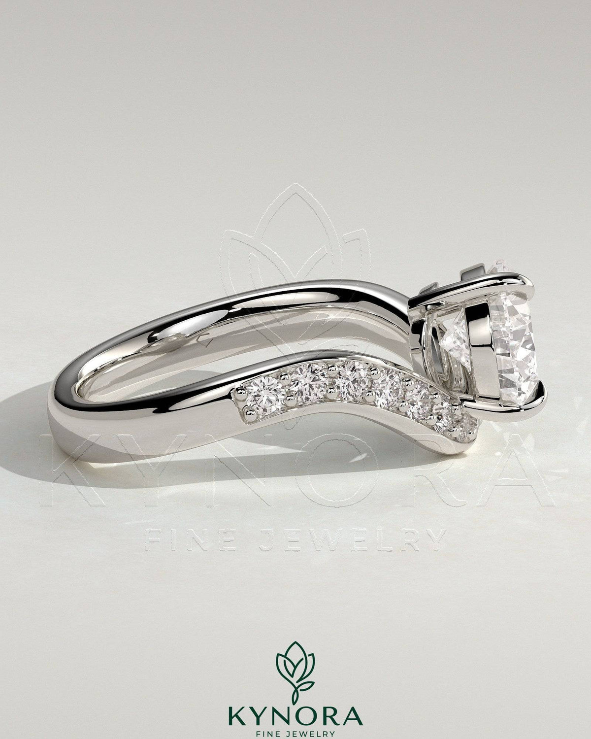 Kynora CJ 2ct pear-shaped diamond solitaire engagement ring with pave bead set wave band in east-west setting.
