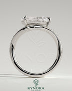 Kynora CJ 2ct pear-shaped diamond solitaire engagement ring with bead-set pave wave band and east-west setting.