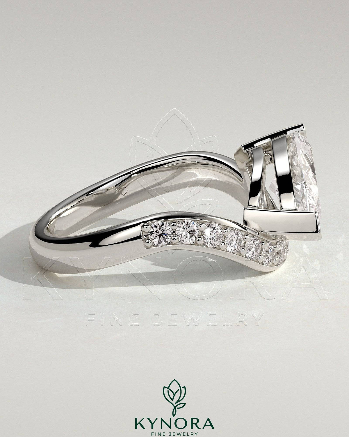 Kynora CJ 2ct marquise claw solitaire engagement ring with bead-set pave wave band in east-west setting.