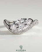 Kynora CJ 2ct marquise claw solitaire engagement ring with bead set pave wave band in east-west setting, elegant and sparkling jewelry piece.