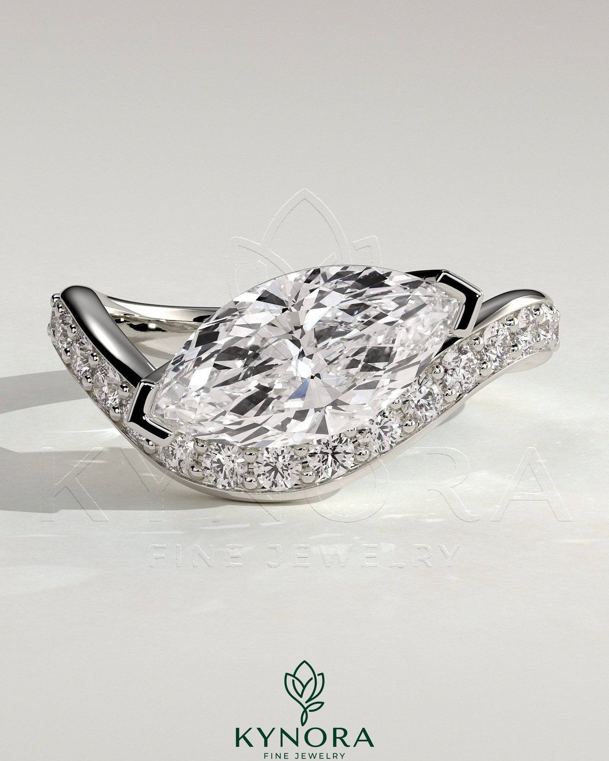 Kynora CJ 2ct marquise claw solitaire engagement ring with bead set pave wave band in east-west setting, elegant and sparkling jewelry piece.