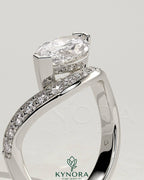 Kynora CJ 2ct marquise claw solitaire engagement ring with bead set pave wave band in east-west setting, showcasing intricate design.