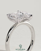 Kynora CJ 1.8ct pear-shaped and 1.5ct marquise-cut Toi et Moi engagement ring with claw settings, elegant and sparkling jewelry piece.