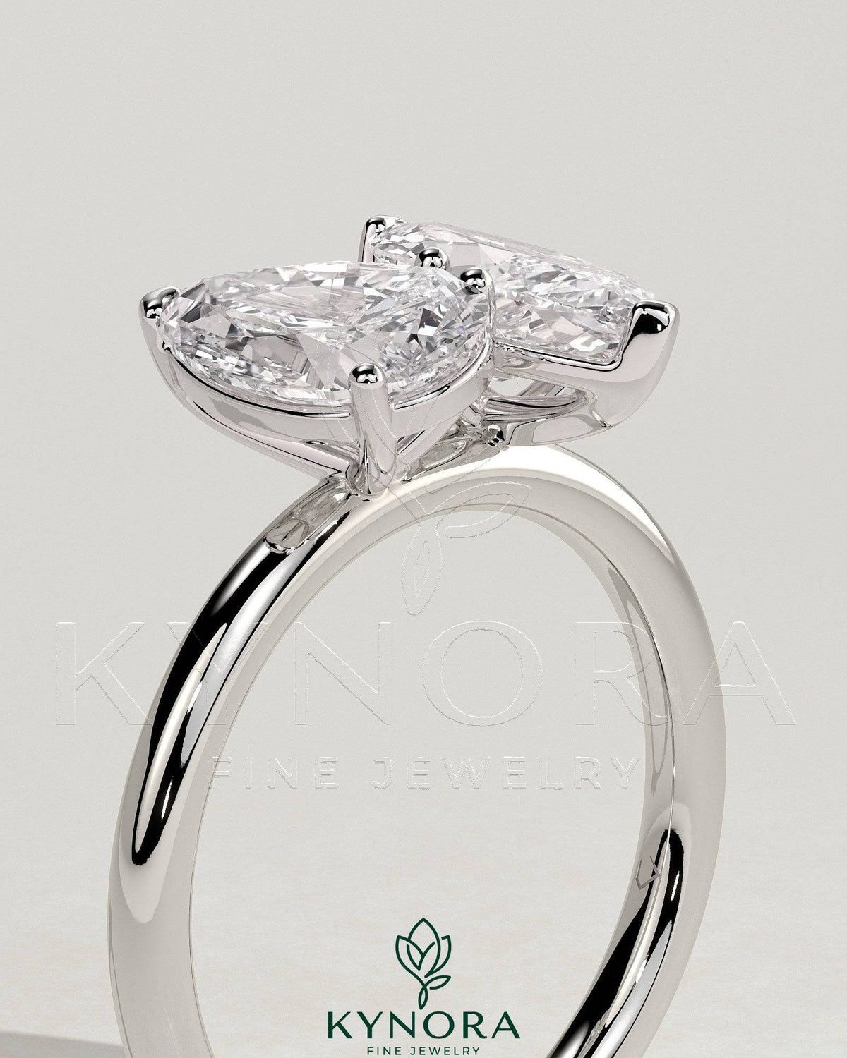 Kynora CJ 1.8ct pear-shaped and 1.5ct marquise-cut Toi et Moi engagement ring with claw settings, elegant and sparkling jewelry piece.