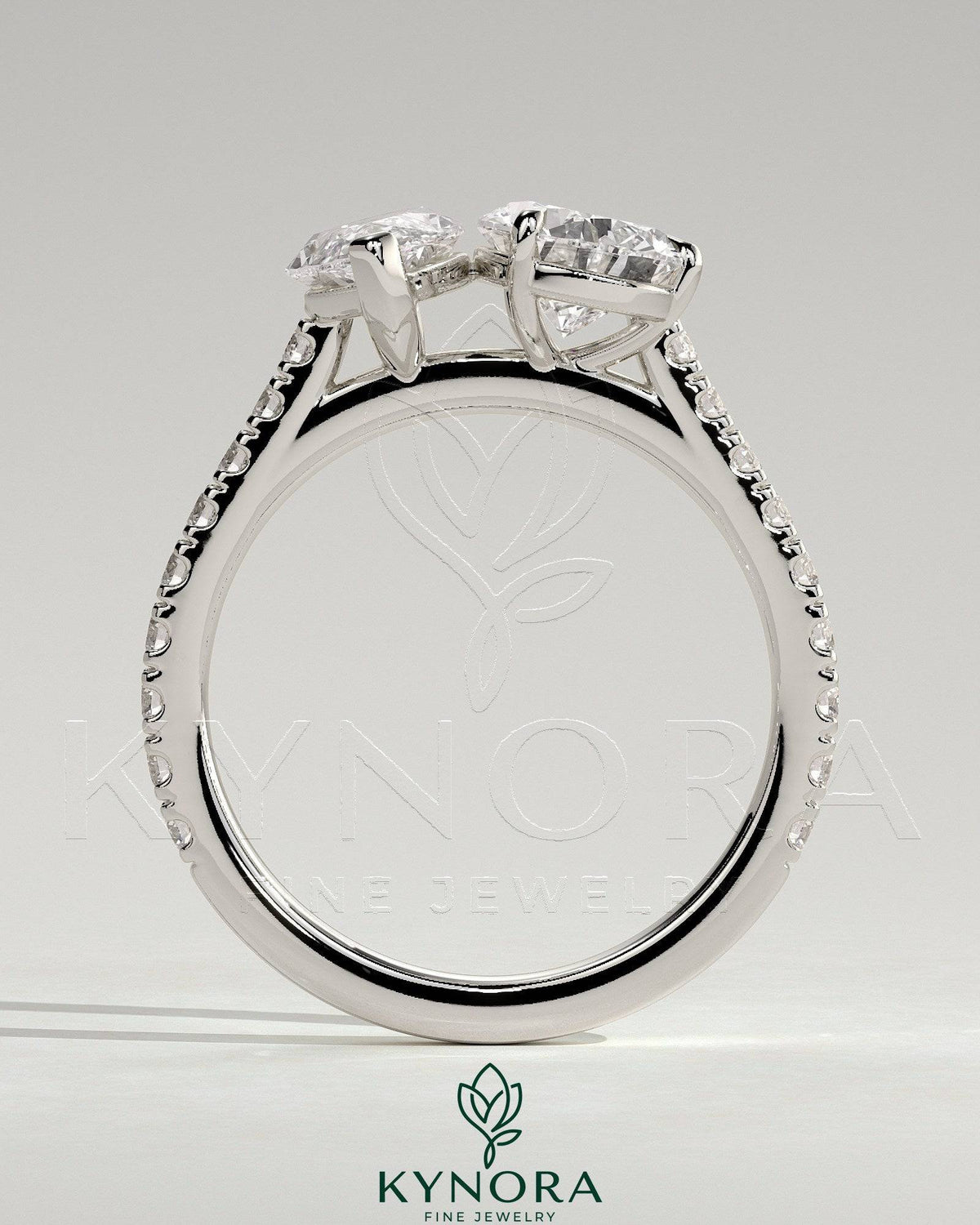 Kynora CJ Toi et Moi engagement ring with 1.5ct marquise and 1.8ct pear-shaped diamonds, pavé band, and cathedral setting