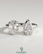 Kynora CJ Toi et Moi engagement ring with 1.23ct oval and 1.15ct pear-shaped diamonds on an open band.