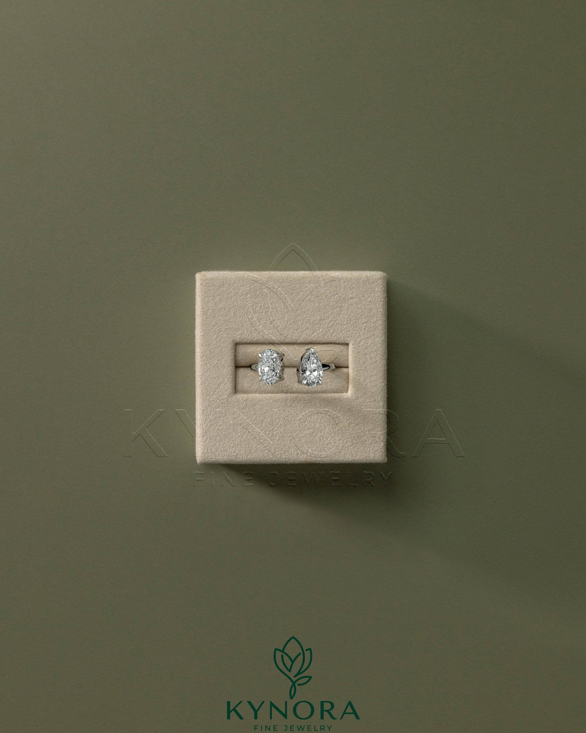 Kynora CJ Toi et Moi engagement ring with 1.23ct oval and 1.15ct pear-shaped diamonds on an open band.