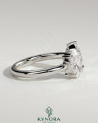 Kynora CJ Toi et Moi engagement ring with 1.23ct oval and 1.15ct pear-shaped diamonds on an open band setting.