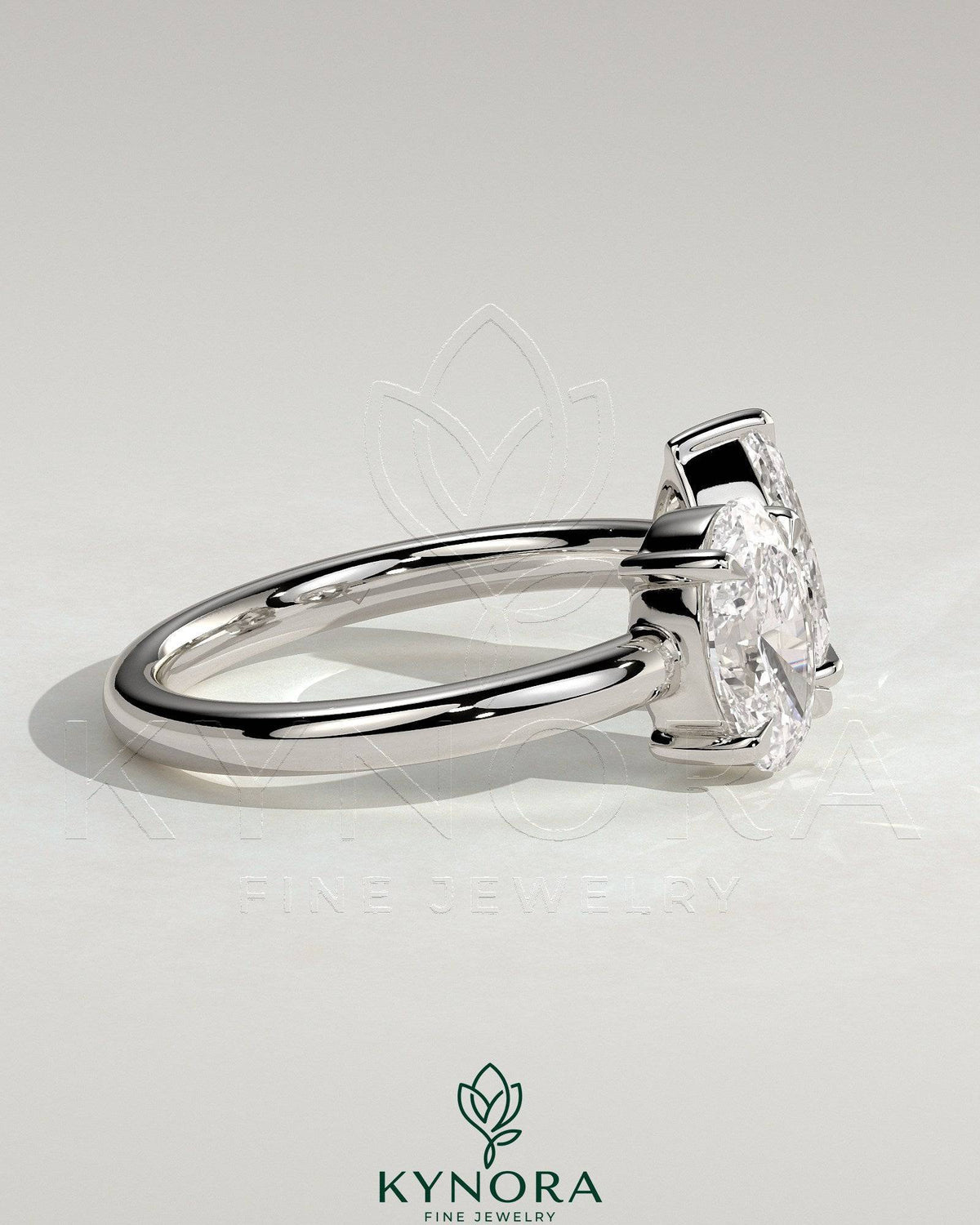 Kynora CJ Toi et Moi engagement ring with 1.23ct oval and 1.15ct pear-shaped diamonds on an open band setting.