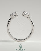 Kynora CJ Toi et Moi engagement ring featuring a 1.23ct oval and 1.15ct pear-shaped diamonds with open band design.