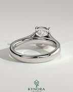 Vintage style 2ct elongated cushion claw solitaire engagement ring with bezel frame, star accent stones, milgrain, and tapered band.