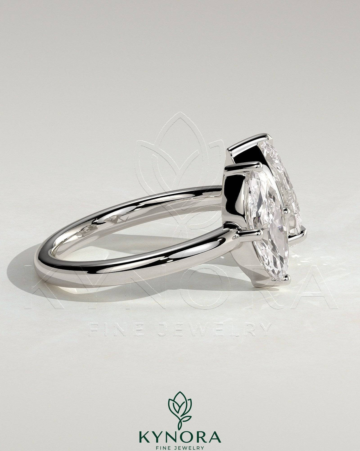 Kynora CJ Toi et Moi engagement ring featuring 1.15ct marquise and 1.65ct pear-shaped diamonds on an open band.