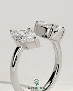 Kynora CJ Toi et Moi engagement ring featuring 1.15ct marquise and 1.65ct pear-shaped diamonds with an open band design.