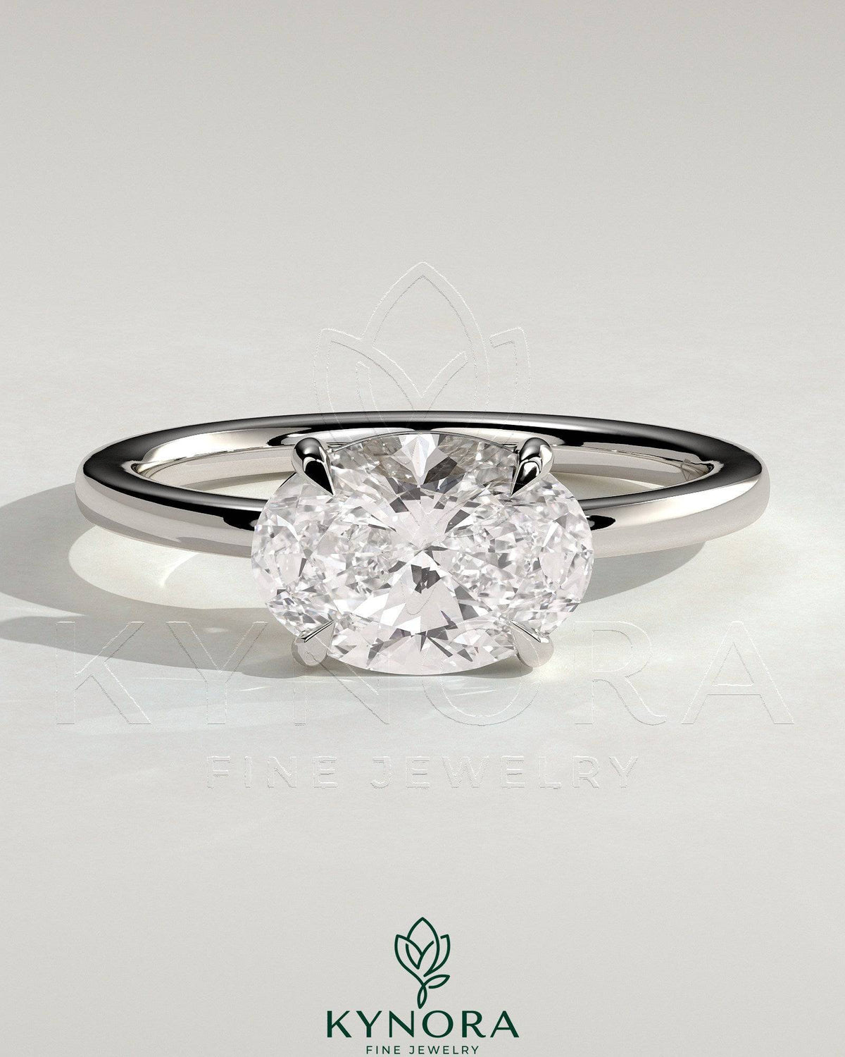 Kynora CJ 2ct oval east-west claw solitaire engagement ring with raised basket gallery, showcasing a sparkling oval diamond. Main image