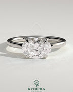Kynora CJ 2ct oval east-west claw solitaire engagement ring with raised basket gallery, showcasing a sparkling oval diamond.