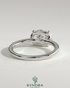 Oval east-west claw solitaire engagement ring by Kynora CJ with raised basket gallery and 2-carat diamond.