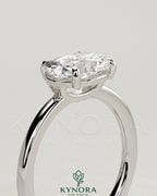 Kynora CJ 2ct oval east-west claw solitaire engagement ring with raised basket gallery setting in gold.