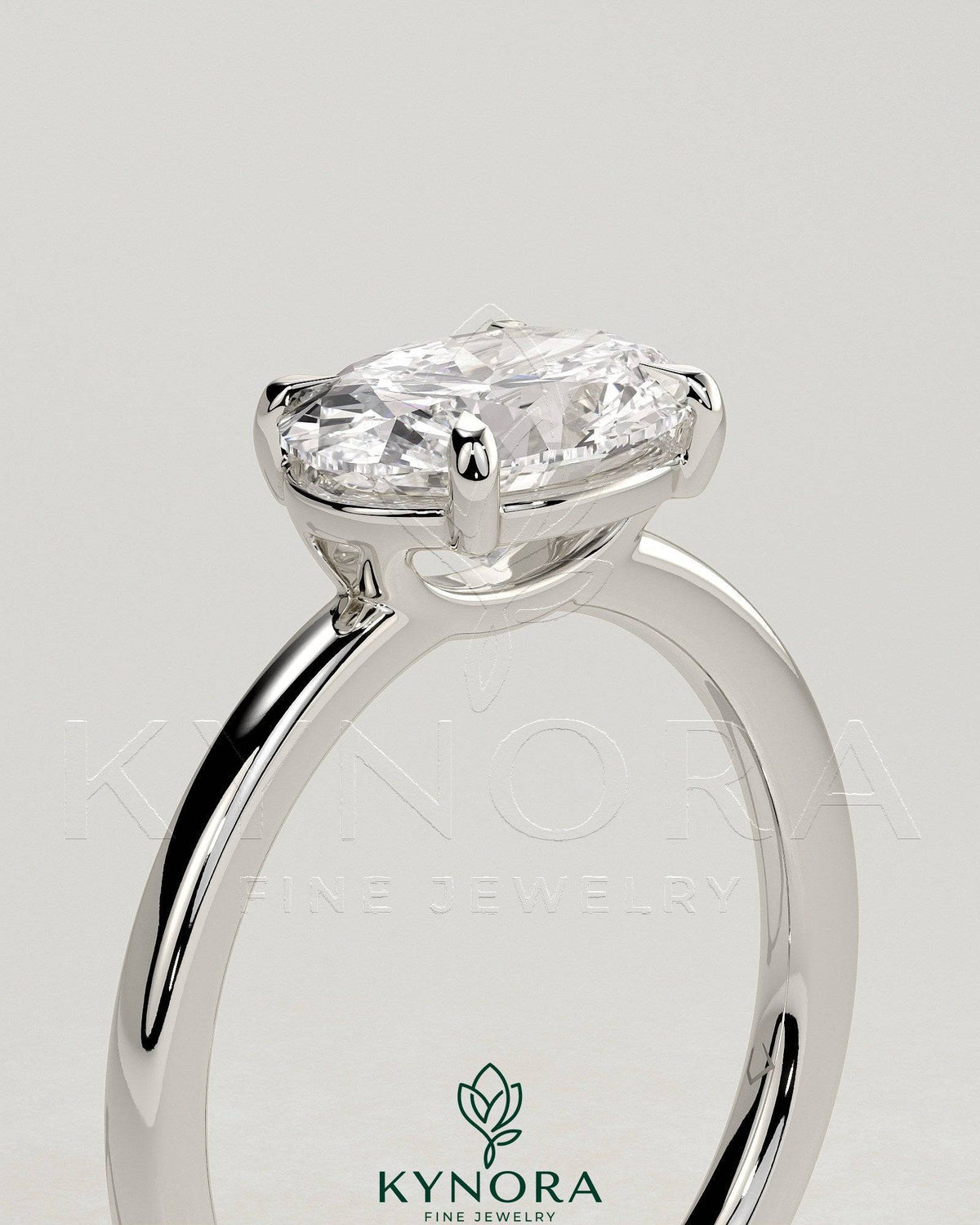 Kynora CJ 2ct oval east-west claw solitaire engagement ring with raised basket gallery setting in gold.