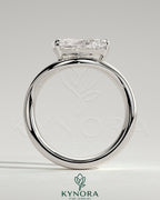 Kynora CJ 2ct pear-shaped east-west diamond solitaire engagement ring with wave band design, showcasing elegant jewelry craftsmanship.