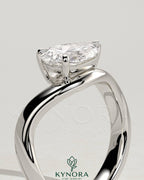 Kynora CJ 2ct pear-shaped East-West claw solitaire engagement ring with wave band, featuring a sparkling pear diamond.