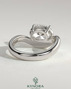 Kynora CJ 2ct oval east-west claw solitaire engagement ring with wave band showcasing sparkling diamond and elegant design