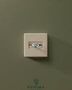 Kynora CJ 2ct oval east-west claw solitaire engagement ring with wave band, featuring a prominent oval diamond setting.
