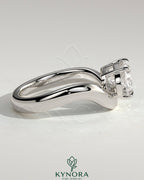 Kynora CJ 2ct oval east-west claw solitaire engagement ring with wave band in polished gold setting.