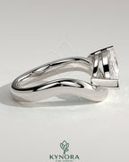 Kynora CJ 2ct marquise east-west claw solitaire engagement ring with wave band, featuring a sparkling marquise diamond.