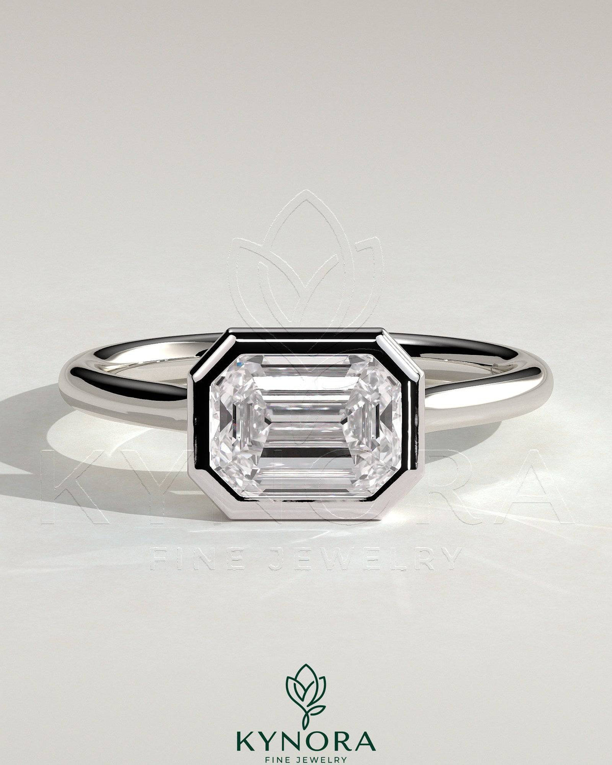 Kynora CJ statement 2ct emerald east-west bezel solitaire engagement ring with open cathedral high setting, showcasing elegant design. Main image