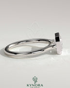 Kynora CJ statement 2ct emerald east-west bezel solitaire engagement ring with open cathedral high setting, showcasing intricate design.