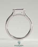 Kynora CJ Statement 2ct emerald East-West bezel solitaire engagement ring with open cathedral high setting, showcasing a prominent emerald gemstone.