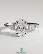 Kynora CJ 2ct oval claw solitaire engagement ring with pear-shaped accents and round shoulder stones, crafted in silver.