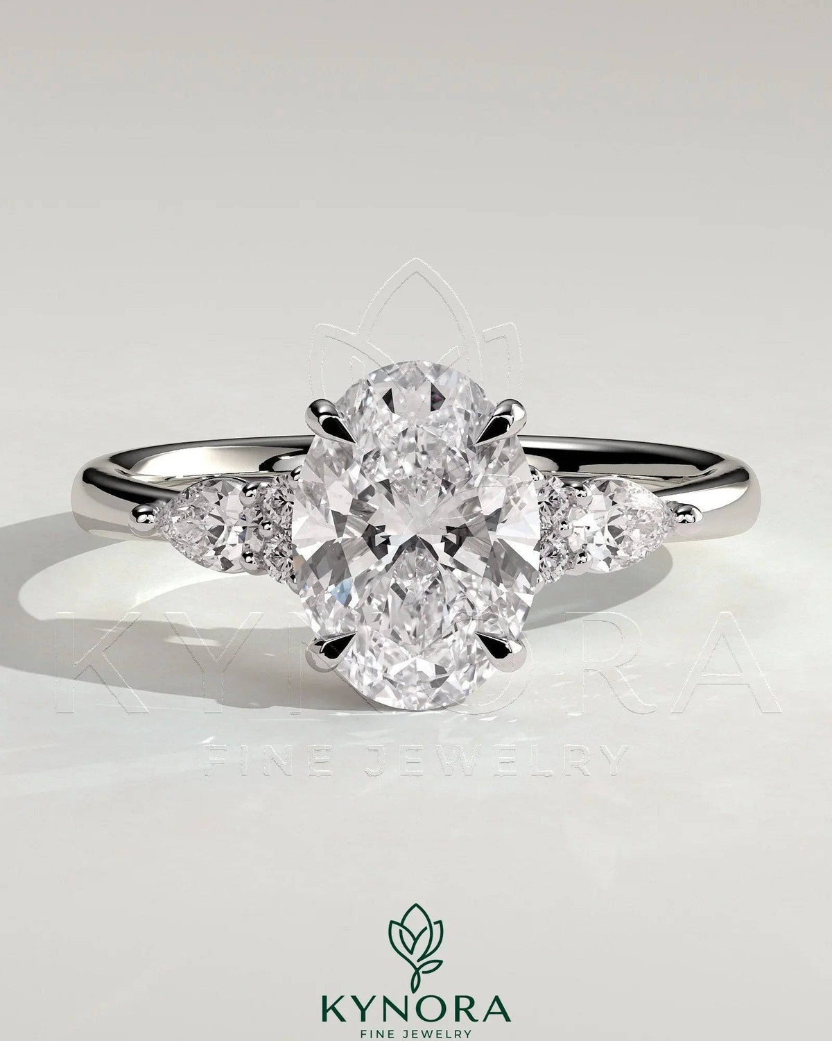 Kynora CJ 2ct oval claw solitaire engagement ring with pear-shaped accents and round shoulder stones, crafted in silver.