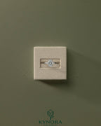 Kynora CJ classic 2ct oval claw solitaire engagement ring with a central diamond and sleek band, showcasing elegant jewelry design.