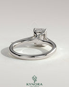 Kynora CJ 2ct emerald claw solitaire engagement ring with spiral gallery and cathedral low setting, featuring a vibrant green emerald.