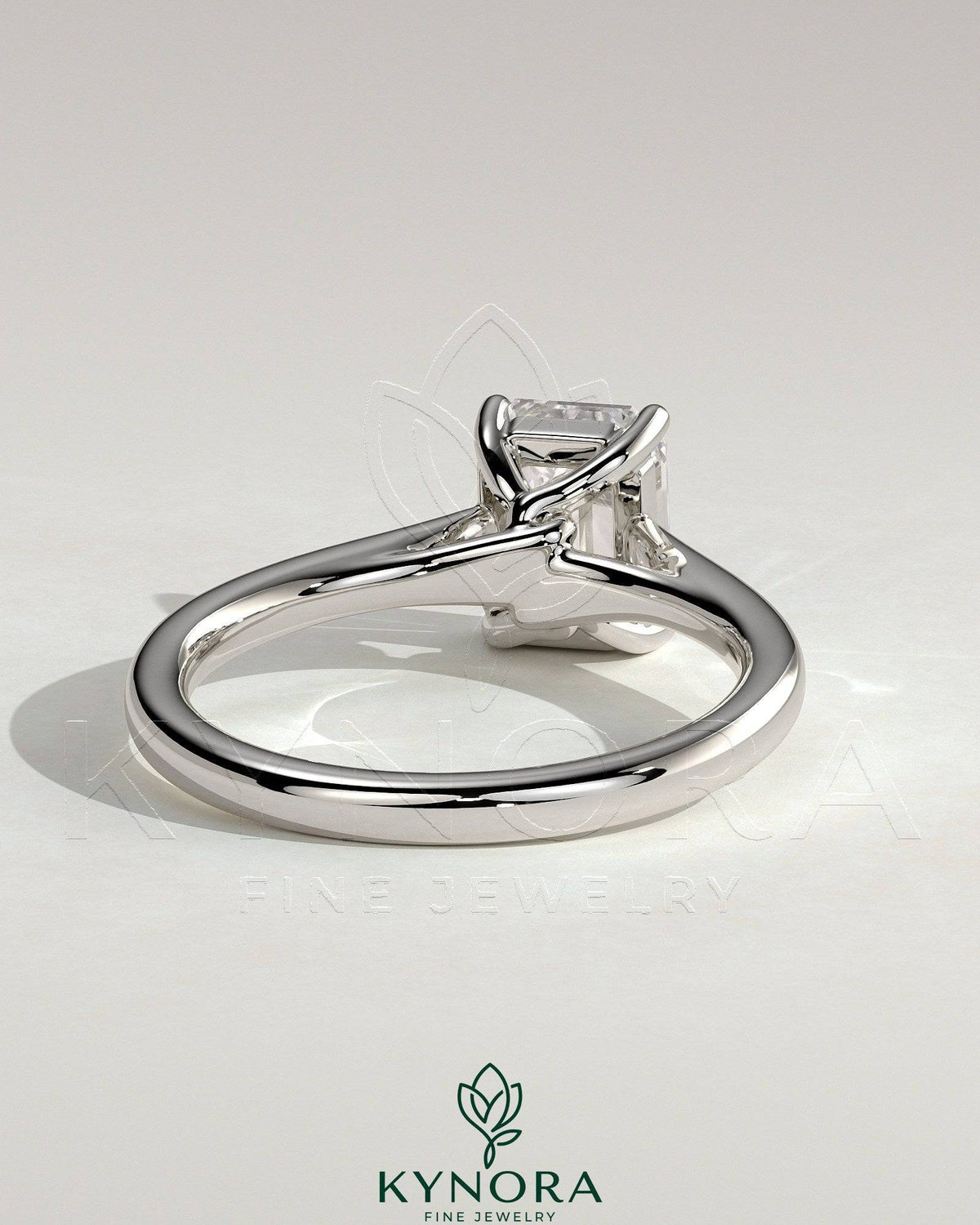 Kynora CJ 2ct emerald claw solitaire engagement ring with spiral gallery and cathedral low setting, featuring a vibrant green emerald.